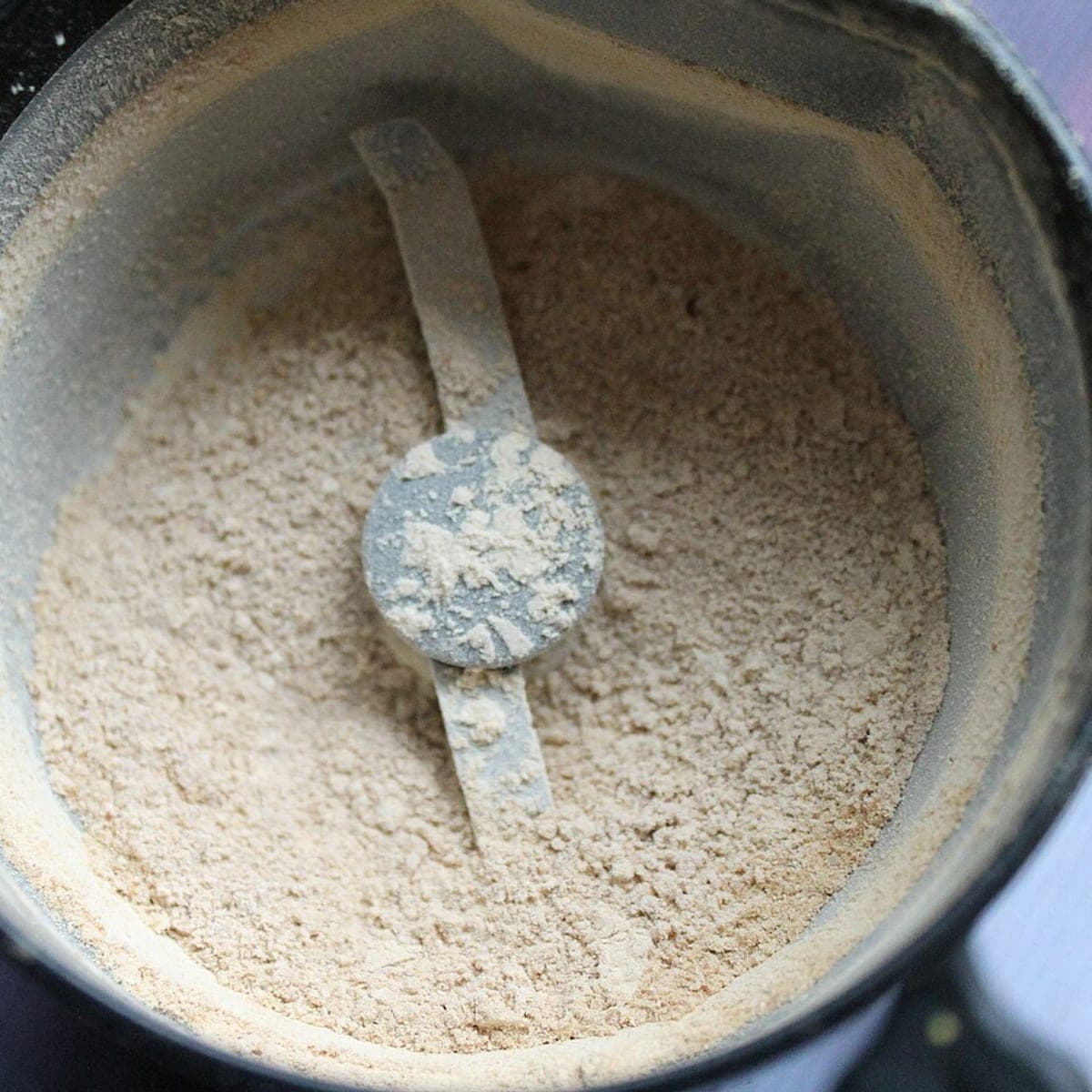 Sample image: dried mushroom milled to a fine pale powder in a grinder bowl.